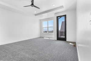 Unfurnished room with carpet, ceiling fan, recessed lighting, and a raised ceiling