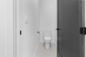 Bathroom with toilet and baseboards