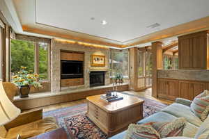 Living area with light wood-style flooring, a fireplace, and recessed lighting