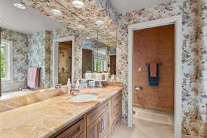 Full bathroom with wallpapered walls, vanity, a stall shower, tile patterned flooring, and a bathtub
