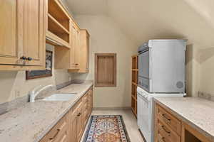 Laundry room with estacked washer and dryer and cabinet space