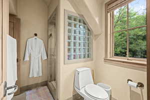 Bathroom with toilet and tiled shower