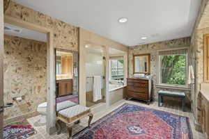Full bath with vanity, a garden tub, wallpapered walls, tile patterned flooring, and recessed lighting