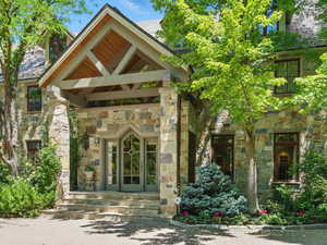 View of exterior entry featuring stone siding