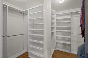 Walk in closet featuring wood finished floors