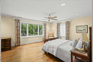 Bedroom with crown molding, light wood finished floors, recessed lighting, and ceiling fan