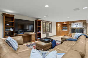 Living room with built in shelves and recessed lighting