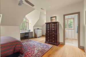 Bedroom featuring hardwood / wood-style flooring, a ceiling fan, recessed lighting, and vaulted ceiling