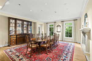 Dining room with crown molding, light wood-style flooring, and recessed lighting
