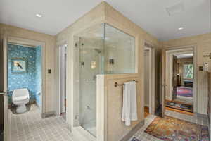 Full bathroom featuring a shower stall, tile patterned flooring, and wallpapered walls
