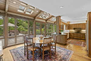 Dining space with light wood finished floors, wood ceiling, and recessed lighting