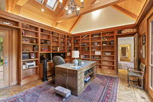 Office space with a chandelier, built in shelves, and wood ceiling