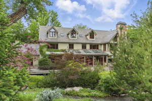 View of front of home featuring stucco siding, a high end roof, and a standing seam roof