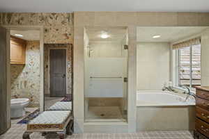 Bathroom with a stall shower, a bidet, and a garden tub