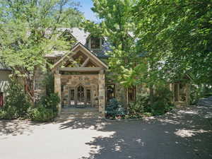 View of front of property featuring stone siding and french doors