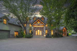 View of front of property with stone siding and stucco siding