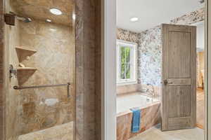 Full bath featuring a bath and a shower stall