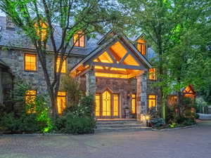 Property entrance featuring stone siding and a high end roof