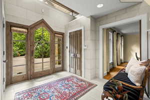 Entryway featuring light tile patterned floors