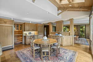 Dining space with wood ceiling, light wood-style floors, recessed lighting, and ornate columns