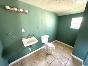 Bathroom featuring a textured ceiling and tile patterned floors