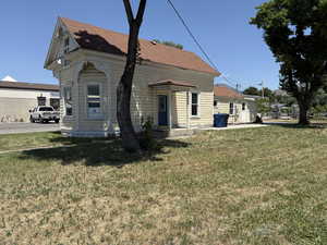 Rear view of property featuring a lawn