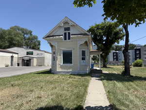 Victorian-style house featuring a front yard
