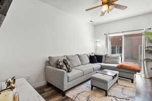 Living room featuring wood finished floors and a ceiling fan