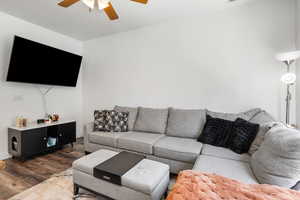 Living room featuring ceiling fan and wood finished floors