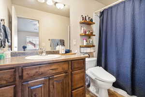 Full bathroom with vanity, tile patterned flooring, and curtained shower
