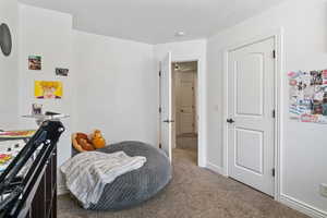 Bedroom featuring carpet floors and baseboards