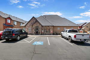 View of property with uncovered parking