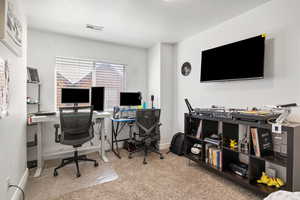 Carpeted office with baseboards