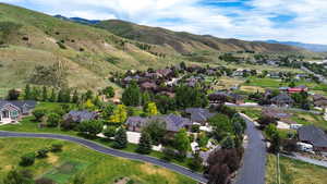 Aerial overview of property's location with nearby suburban area and mountains