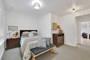 Bedroom #4 featuring light colored carpet and baseboards and shared bathroom