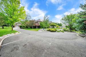 View of front of property featuring a front yard and extra parking