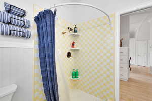 ADU Full bathroom featuring a stall shower and wood finished floors