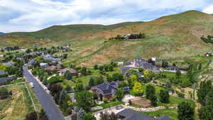 Aerial view of property's location with a mountainous background and nearby suburban area