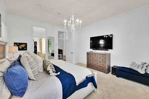 Owner suite featuring a chandelier and crown molding