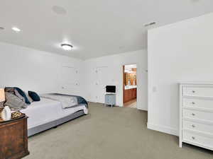 Bedroom #4 with light colored carpet and shared bathroom