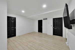 Foyer with light wood-type flooring and recessed lighting