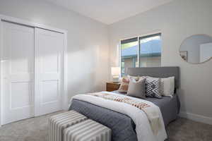 Bedroom featuring carpet floors and a closet