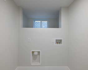 Laundry room featuring hookup for a washing machine and baseboards