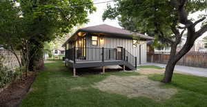 Back of house with roof with shingles and board and batten siding