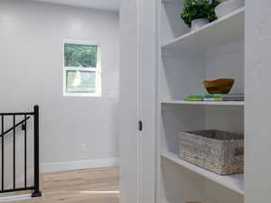 Hallway with wood finished floors and baseboards