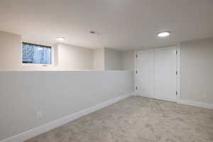 Finished below grade area with carpet floors and baseboards