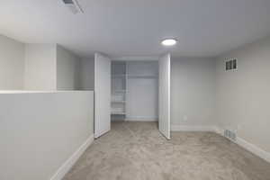 Unfurnished bedroom featuring carpet flooring and a closet