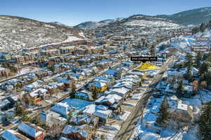 Snowy aerial view with a mountain view and a residential view