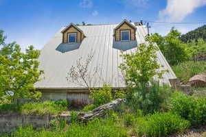 View of side of home with a metal roof