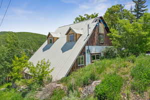 View of side of property featuring a metal roof